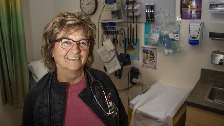 A woman stands in a medical clinic.