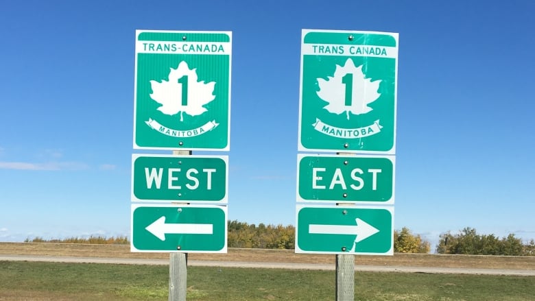 Two green signs with white lettering read 