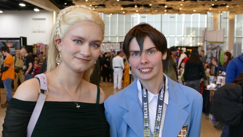 Two people dressed in costumes for an event celebrating cosplay, animation, science fiction and fantasy. 