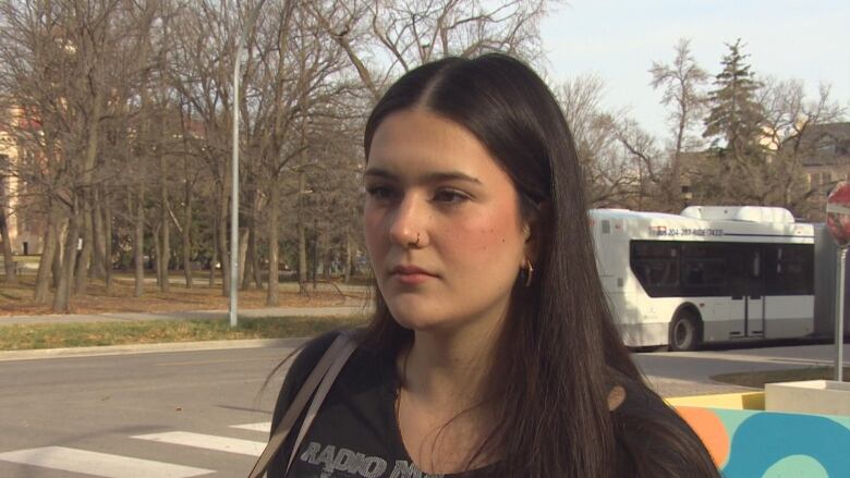 A woman speaks to the camera. 