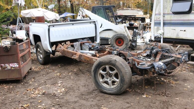 A pickup truck with all of its front section taken apart.