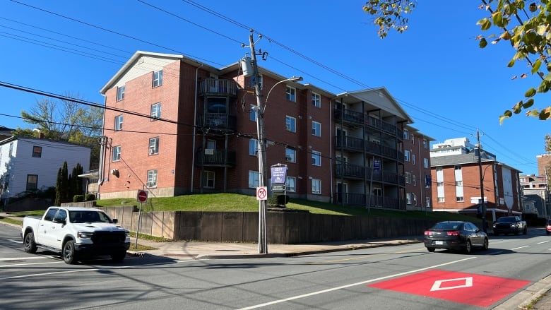 A large brick apartment building is shown. 