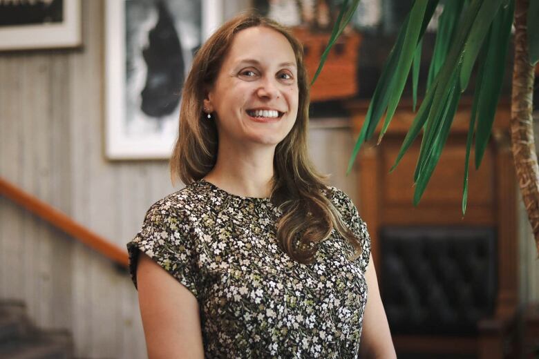 An upper body photo of a smiling woman.