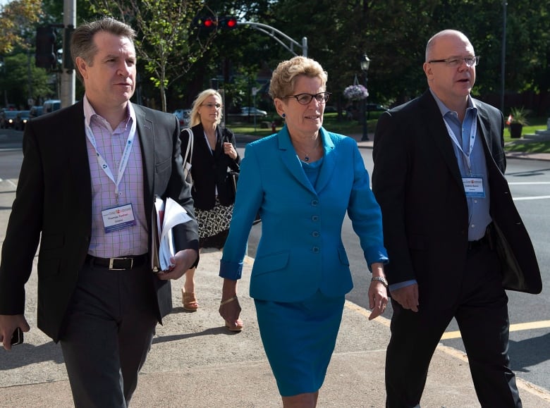 Former Ontario premier Kathleen Wynne is flanked by Thomas Teahen, left, chief of staff and Andrew Bevan, right, principal secretary, in August 27, 2014. Bevan was recently appointed as the Liberal Party's campaign director.