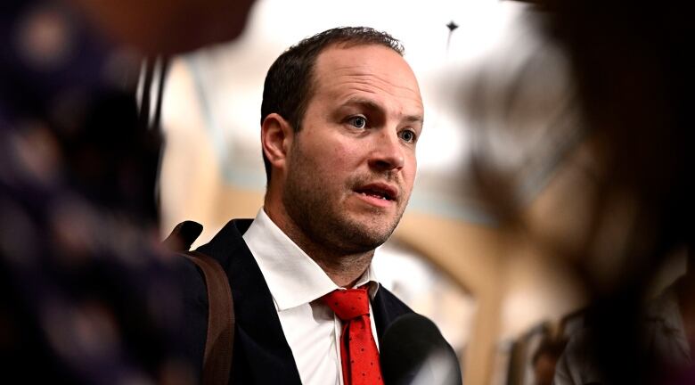 Liberal MP Nathaniel Erskine-Smith takes questions from reporters as he arrives for a meeting of the Liberal caucus, on Parliament Hill in Ottawa, on Wednesday, June 5, 2024.