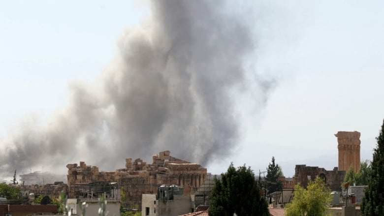 Smoke is seen following an Israeli airstrike near the ruins of the ancient Roman Temple of Bacchus.