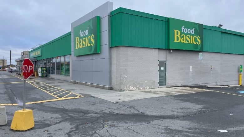 A grocery store with a green sign that says Food Basics.