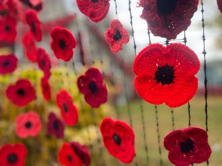 A bright red and black knitted poppy 