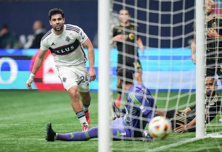 A soccer player celebrates after scoring a goal. 