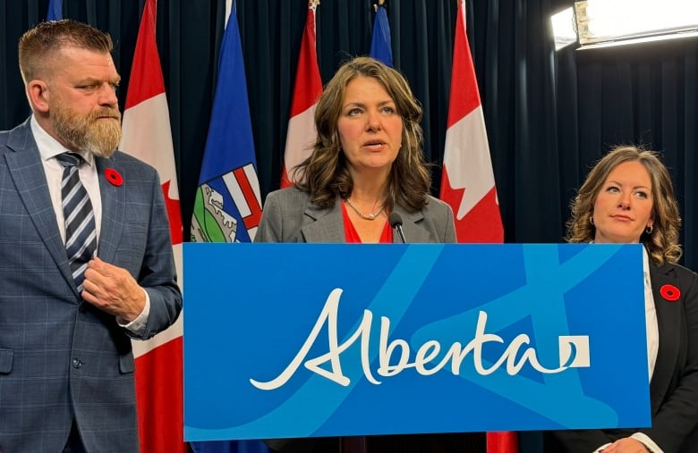 Alberta Premier Danielle Smith, Alberta Minister of Energy and Minerals Brian Jean, left, and Environment Minister Rebecca Schulz, right speaking in Edmonton Monday.