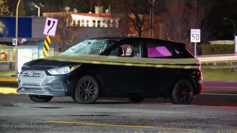 A photo of a car that has a broken windshield following a collision. 