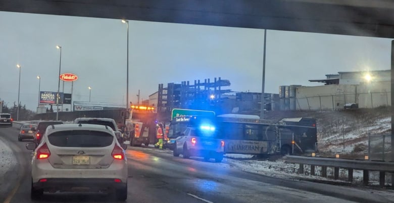 A bus on the side of Ring Road and cars on the road.