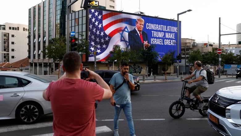 Republican presidential nominee and former U.S. President Donald Trump appears on a congratulatory billboard for the 2024 U.S Presidential Election, in Tel Aviv, Israel, November 6, 2024. 