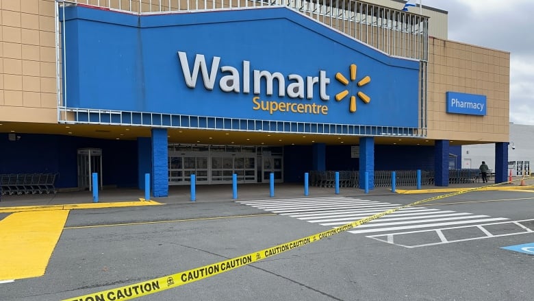 Yellow caution tape is shown outside the front of a Halifax Walmart store.