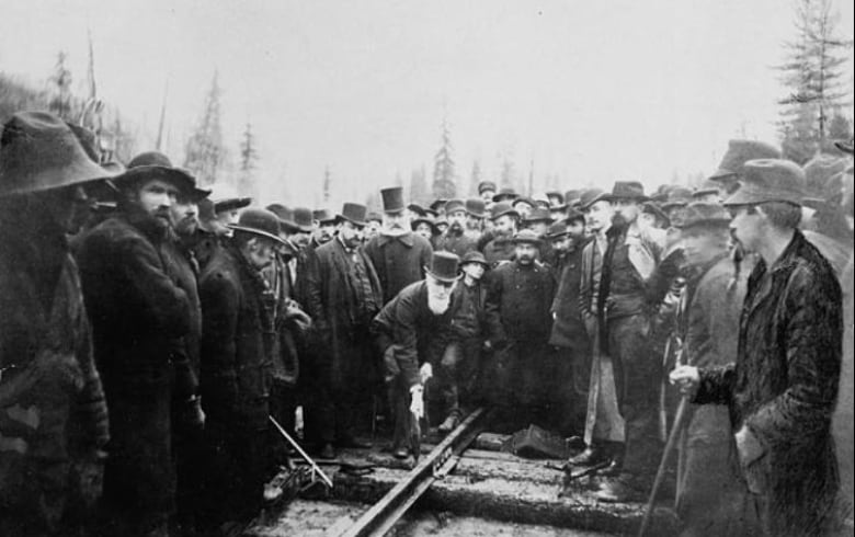 Hon. Donald A. Smith driving the last spike to complete the Canadian Pacific Railway in Craigellachie, B.C., on November 7, 1885. 