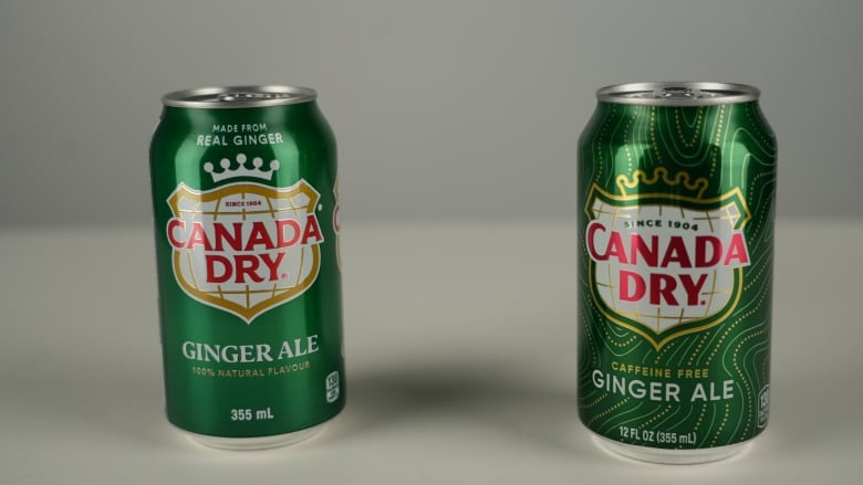 Two cans of Ginger Ale stand side by side. One says 