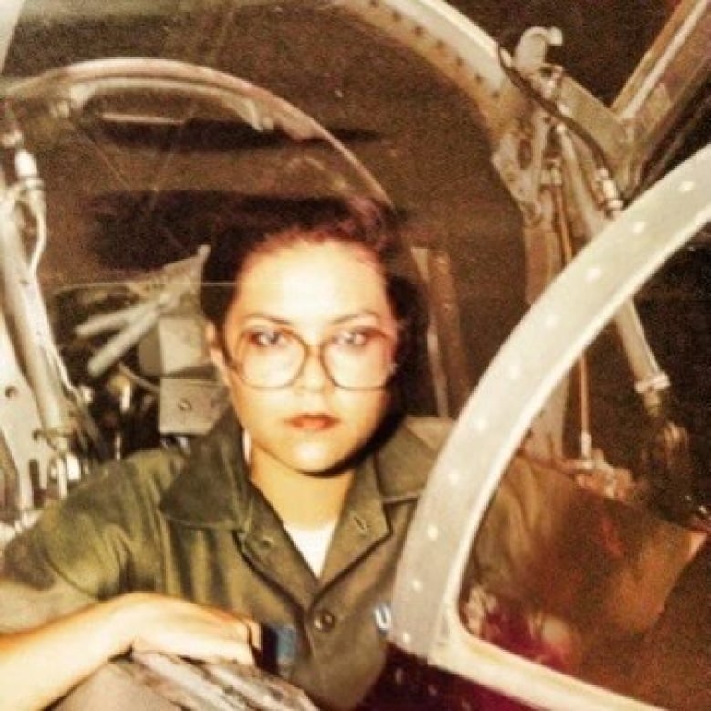 A picture of an Indigenous veteran of the US Air Force working on a plane in the 70's.