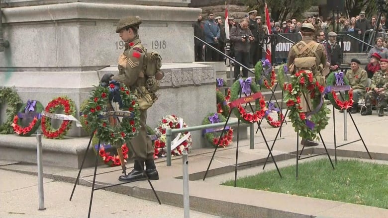 Photo of poppy wreaths at a cenotaph 