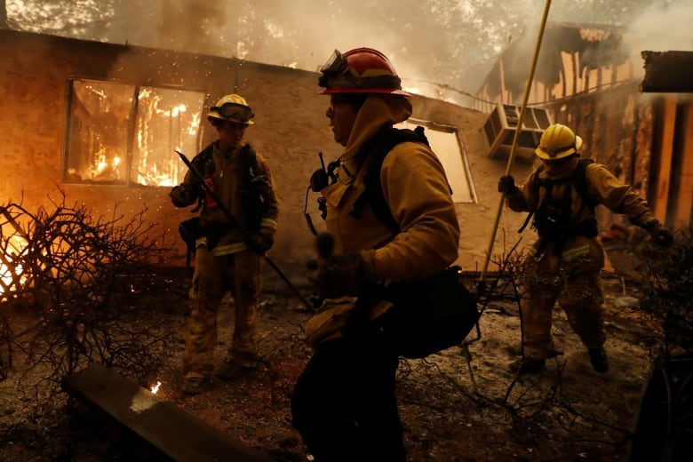 Firefighters working to tame the 2018 Camp wildfire in Paradise, California.