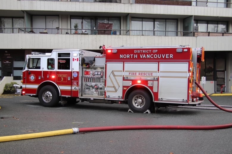 A fire truck is seen in front of a building.