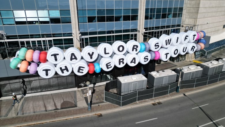 Taylor Swift signage that says Taylor Swift: The Eras Tour in the shape of friendship bracelet beads. 