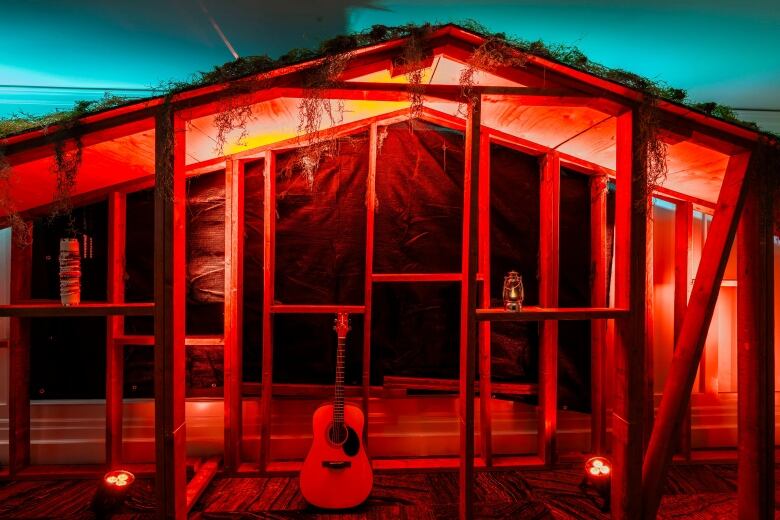 An installation of a whimsical backdrop with a guitar in a hotel.