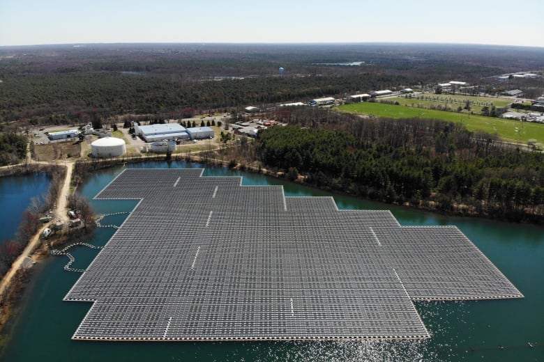 An array of solar panels float on top of a water storage pond in New Jersey. The U.S. Inflation Reduction Act has spurred investment into clean energy in the U.S. 