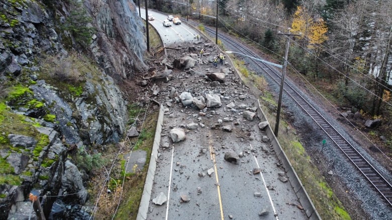 Rock fall across a two-lane highway. 