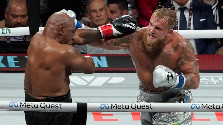 Two men's boxers trade punches in a boxing ring.