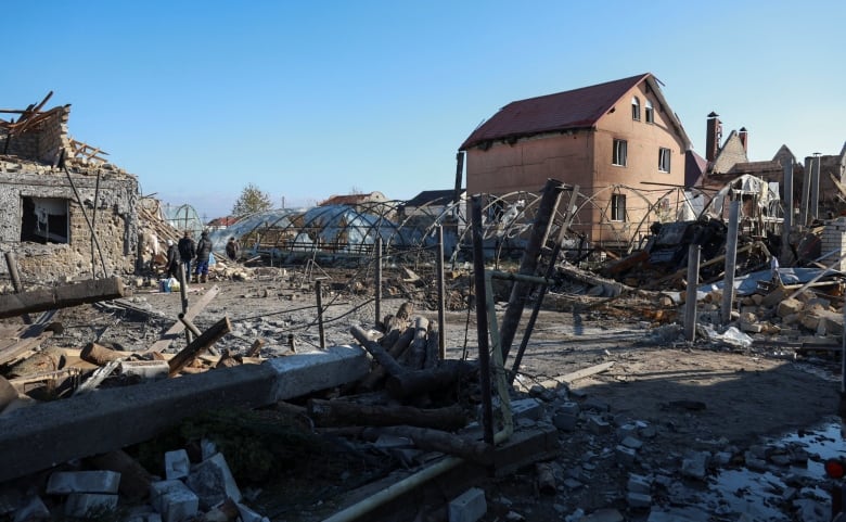 A view shows a residential area heavily damaged by a missile strike.