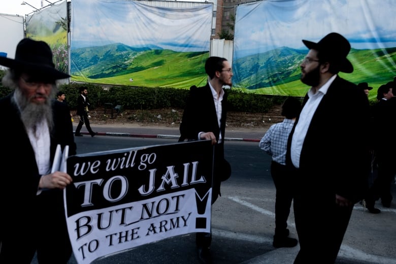 Men in suits at a protest.