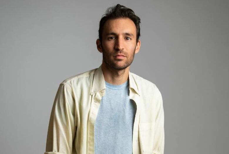 Alec Karakatsanis is looking forward at the camera in a shot showing the chest up in a studio setting