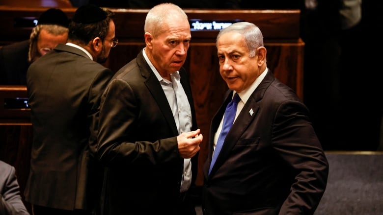 Israeli Defence Minister Yoav Gallant speaks with Prime Minister Benjamin Netanyahu  in the Knesset.