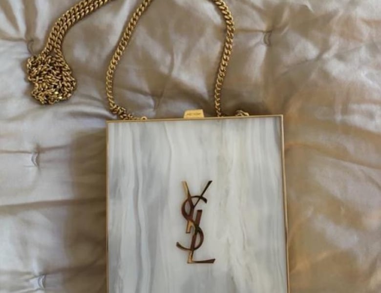 A white Yves Saint Laurent bag.