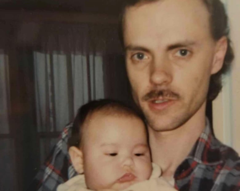 A man holding a baby.