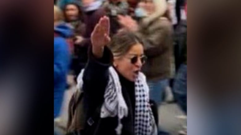 A person raising the arm, making an antisemitic gesture. 