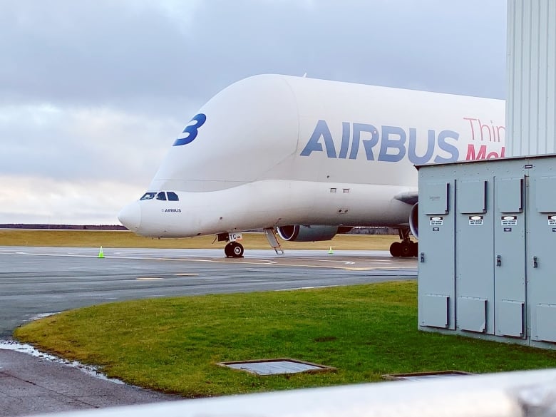 A white airplane with an odd-looking tall 