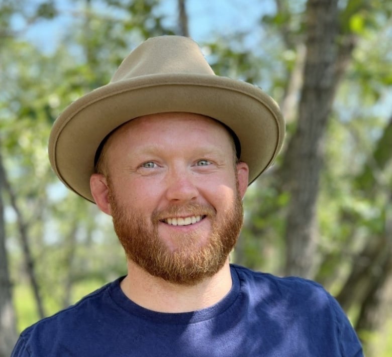 A bearded man in a hat.