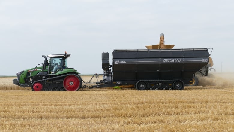 A tractor is shown in a wheat field.