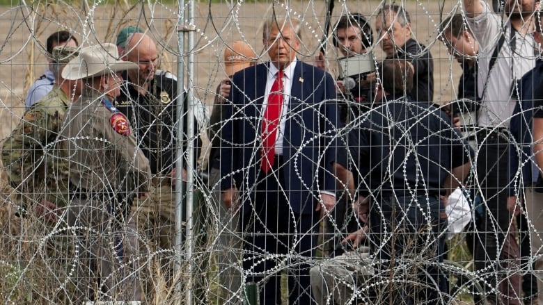 Trump seen through wire fence