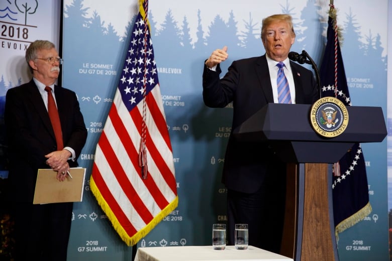 National Security Adviser John Bolton looks on as President Donald Trump speaks during a news conference at the G-7 summit, Saturday, June 9, 2018, in La Malbaie, Quebec, Canada. 